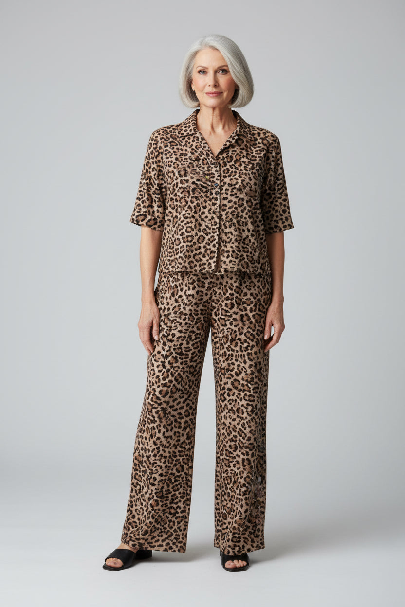 Person wearing a leopard print outfit in an indoor setting