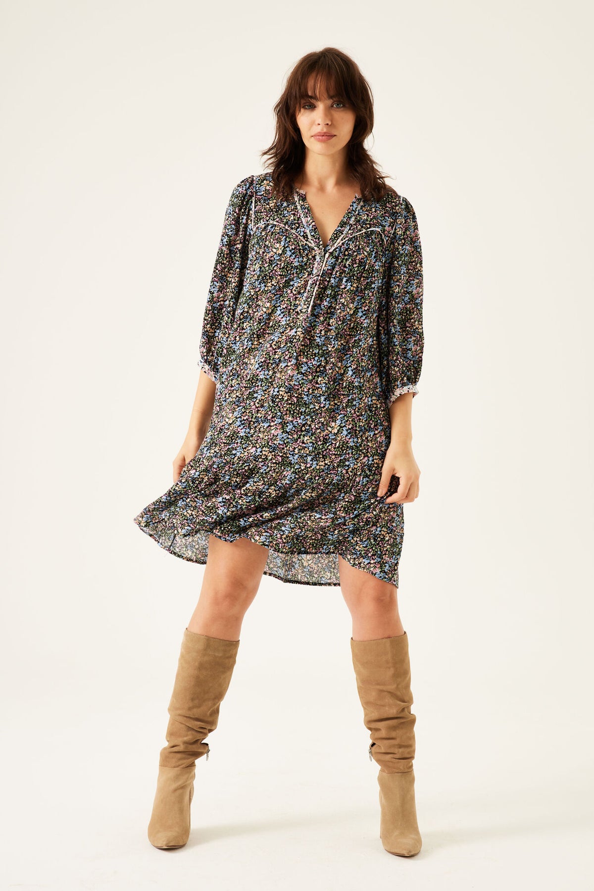 Floral print women's dress with V-neck and 3/4 sleeves, paired with knee-high boots