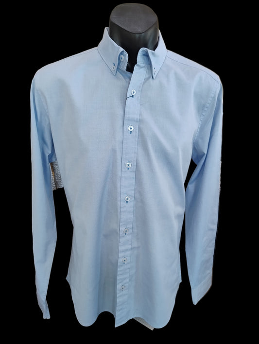 Light blue button-up shirt on a mannequin in a store setting