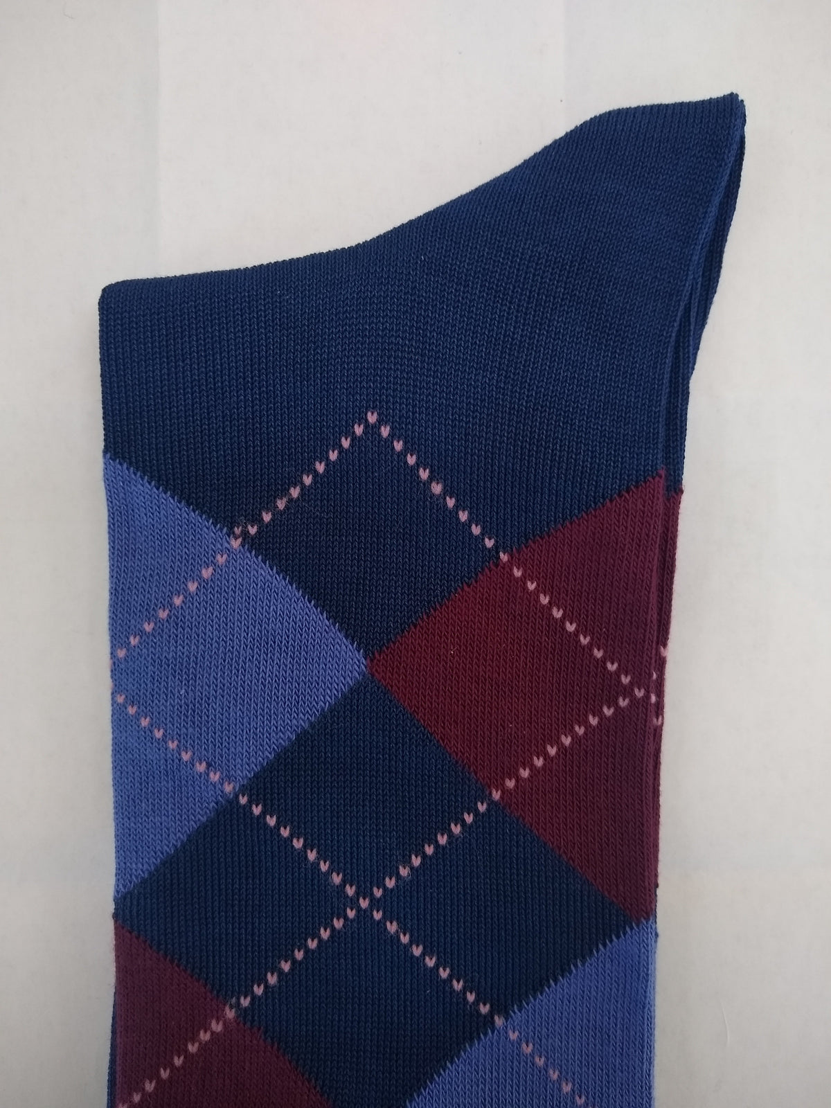 Blue and burgundy argyle patterned men's dress socks with pink heart accents